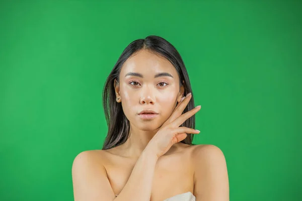 Thinking young asian woman looking at the camera on an isolated background