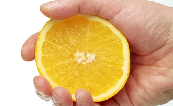 Male hand squeezing an orange Royalty Free Stock Photos