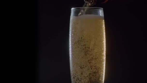 Close Beer Pouring Bottle Misted Glass Black Background Bubbles Rising — Stock Video
