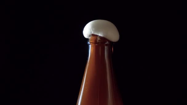 Close Beer Foam Rising Brown Glass Bottle Side View Black — Stock Video