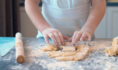 Girl making cookies with a cookie cutter