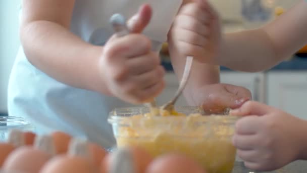 Mani di due bambini che mescolano burro con zucchero e uova — Video Stock