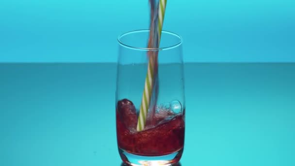 Close Cherry Juice Pouring Glass Splashes Bubbles Blue Bacground Jet — 图库视频影像