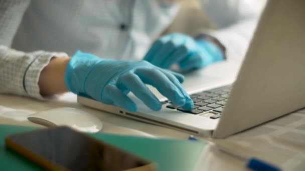 Female hands in gloves typing on a computer — Stock Video