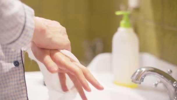 Young woman wiping hands with a disposable towel — Stock Video