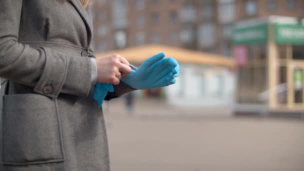 Handen van een vrouw die beschermende handschoenen aantrekt — Stockvideo