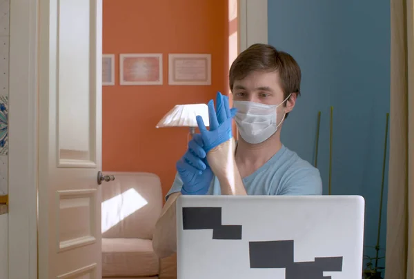 Young Man Working Home Sitting Computer Putting Blue Rubber Gloves — Stock Photo, Image