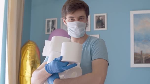 Funny man holding many rolls of toilet paper — Stock Video