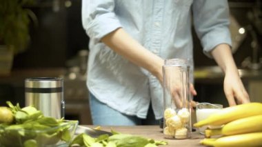 Kadın smoothie pişiriyor.