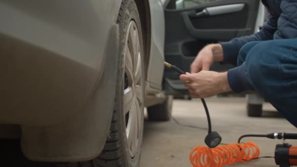 Close Male Hands Screwing Car Pump Tire Valve Back Wheel — Stock Video