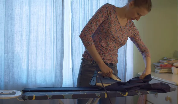 Attractive Smiling Woman Ironing Trousers Her Husband Bright Room Domestic — Stock Photo, Image