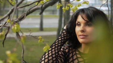 Ağaç dalları arasında çekici bir kadın