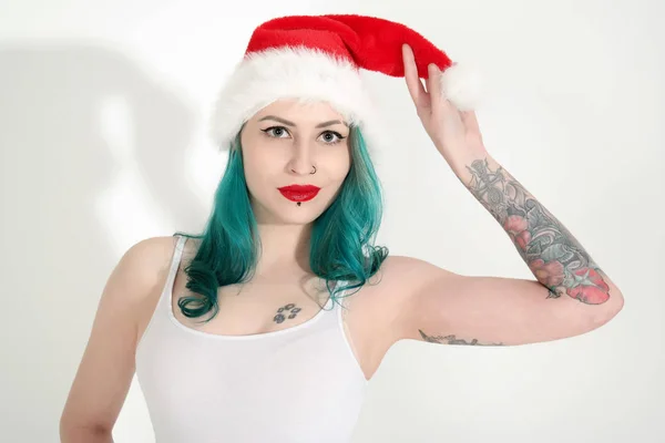 Beautiful young woman in red Christmas hat — Stock Photo, Image