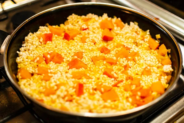 Pumpkin and rice cooking in a pan for risotto italian recipe