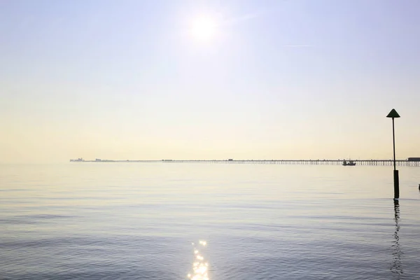 Pier at southend viewed from the seashore on a calm day — Stock Photo, Image