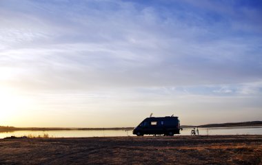 caravan silhouette in alqueva lake, Portugal clipart