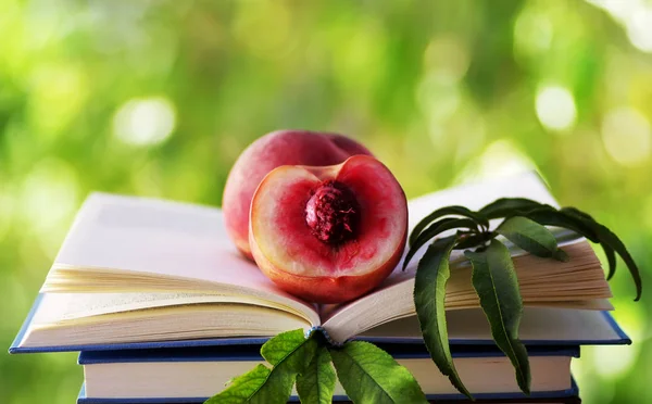 Half of peach in open book — Stock Photo, Image