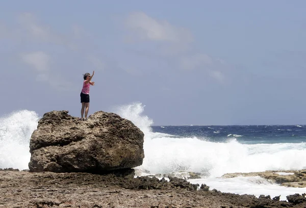 Woman doing a yoga dance on an Ocean beach
