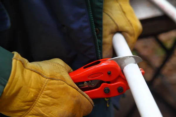 Workman taglia il tubo in PVC — Foto Stock