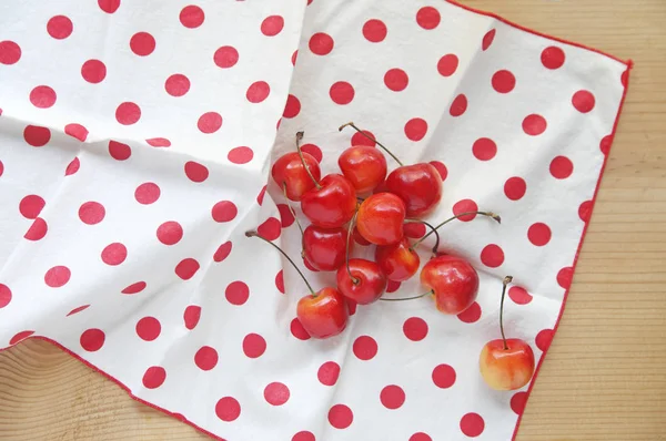 Cherries on polka dot napkin — Stock Photo, Image