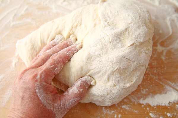 Bread dough with floury hand