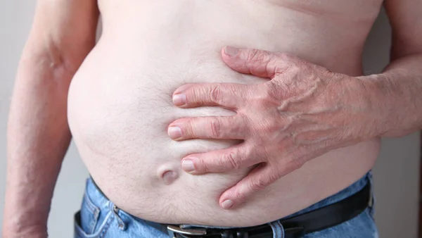 Hombre Sin Camisa Jeans Con Mano Estómago —  Fotos de Stock