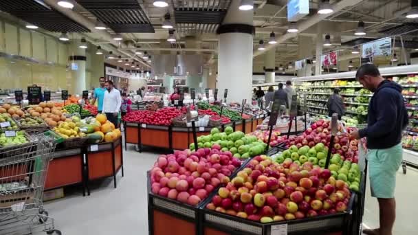 Mensen in de buurt van toonbank met vruchten — Stockvideo
