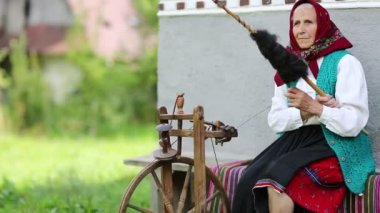 Yaşlı kadın bankta oturur 