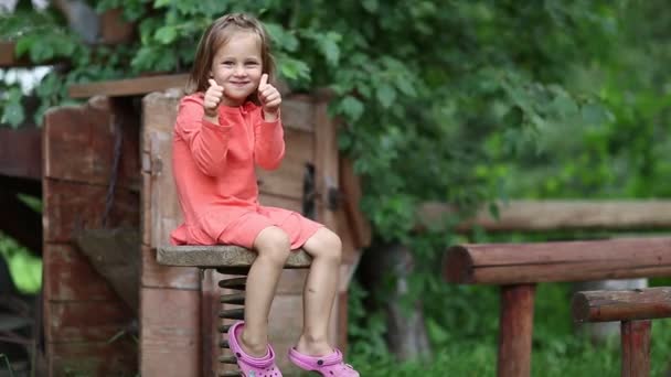 Little girl sits on chair — Stock Video