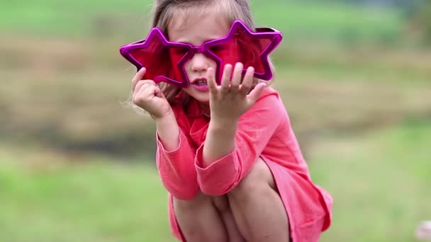 Смешная маленькая девочка в больших очках — стоковое видео