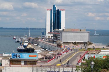 UKRAINE, ODESSA, SEPTEMBER 5, 2019: Road traffic near Odessa Sea Port - largest Ukrainian seaport and one of largest ports on Black Sea. View on passenger terminal and hotel Odessa
