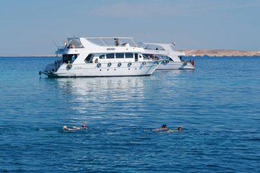 EGYPT, SINAI, SHARM EL SHEIKH, DECEMBER 7, 2019: People on pleasure boat in Red Sea near coast of Sharm El Sheikh city