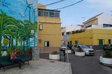 PUNTA BRAVA, TENERIFE ISLAND, SPAIN, SEPTEMBER 26, 2019: Buildings and cars in Punta Brava small town near Puerto de la Cruz city on Tenerife island, Canary islands, Spain