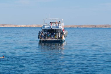 EGYPT, SINAI, SHARM EL SHEIKH, DECEMBER 7, 2019: People on pleasure boat in Red Sea near coast of Sharm El Sheikh city