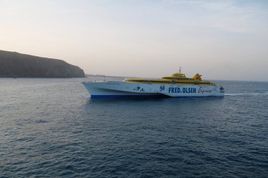 LOS CRISTIANOS, TENERIFE ISLAND, CANARY ISLANDS, ATLANTIC OCEAN, SPAIN, OCTOBER 2, 2019: Ferry Fred Olsen Express or Benchijigua Express calls at port of Los Cristianos city on Tenerife island