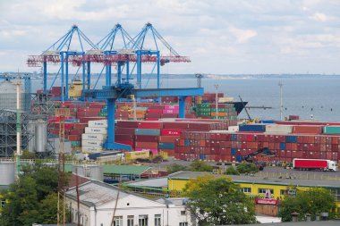 ODESSA, UKRAINE, SEPTEMBER 7, 2019: Cranes and color containers in Odessa port - largest Ukrainian seaport and one of largest ports in Black Sea basin