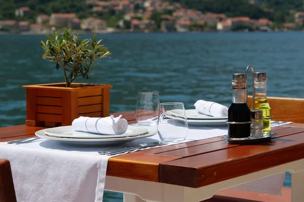 Table in a restaurant with sea view on the coast of Bay of Kotor of the Adriatic Sea in Montenegro