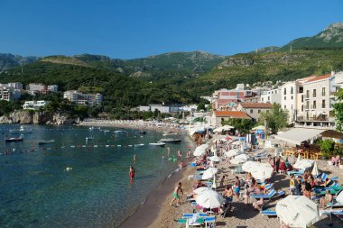 PRZNO, MONTENEGRO, JULE 6, 2019: People and boats in the sea in Przno village in Montenegro, Adriatic Sea