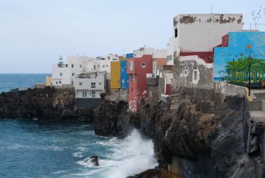 PUNTA BRAVA, TENERIFE ISLAND, SPAIN, SEPTEMBER 28, 2019: Buildings on the rocky coast of Atlantic ocean in Punta Brava small town near Puerto De La Cruz city, Tenerife island, Canary islands, Spain