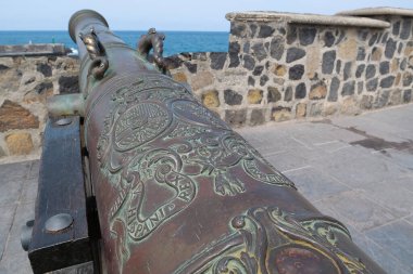 Old cannon with wheels on coast of Tenerife island, Puerto de la Cruz city, Canary islands, Atlantic ocean, Spain clipart