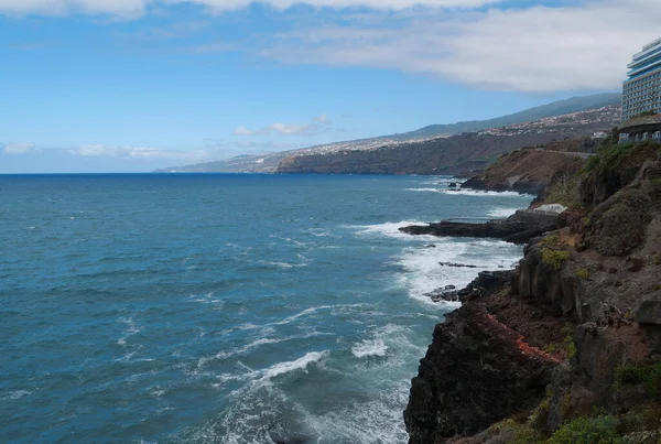 Breaking waves of Atlantic ocean and dangerous rocks near Puerto de la Cruz, Tenerife island, Canary islands, Spain