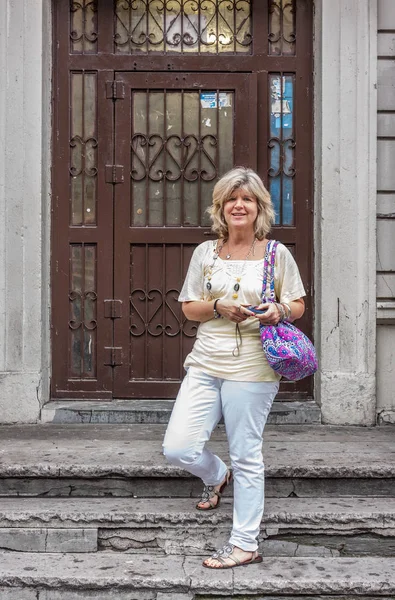 Lady standing on porch steps Royalty Free Stock Photos