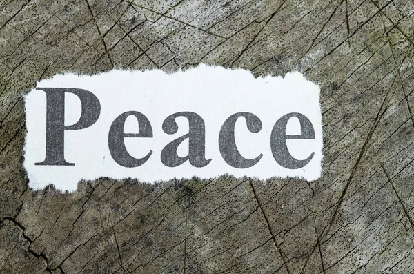 Word peace cut out in a newspaper