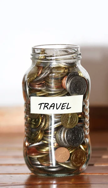 Glass jar filled with peso coin concept for travel - — Stock Photo, Image