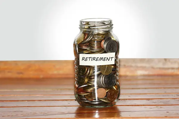 A glass jar full of coins to represents retirement — Stock Photo, Image