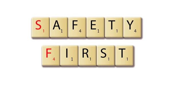 Safety first words arranged in a wooden tile — Stock Photo, Image
