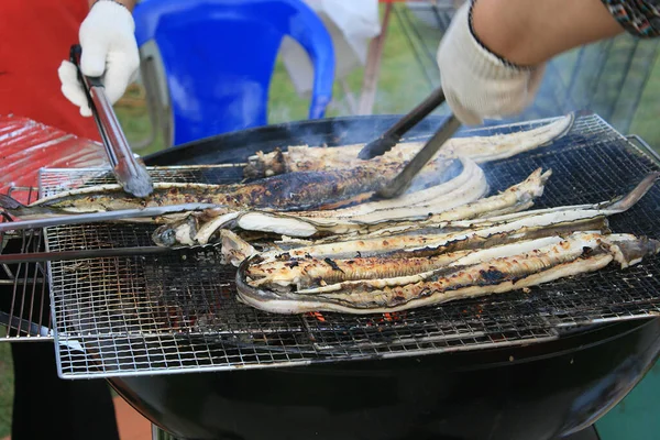 Outdoor grill fish hot flames and charcoal heat