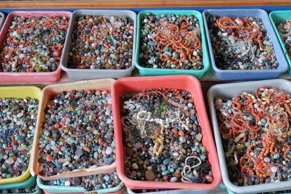 Multi colored beads and tools for making jewelry and crafts, Pushkar, India.