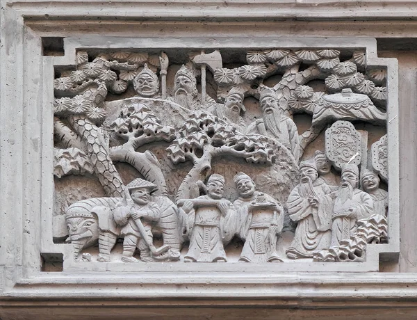 Richly carved stone relief plaque on the doorway of the house in the Grand Canal, ancient town of Yuehe in Jiaxing, Zhejiang Province, China.