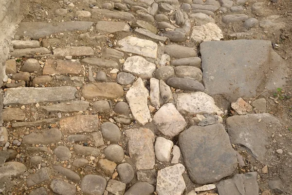 Narrow cobble stone street in Old town Berat, Albania.